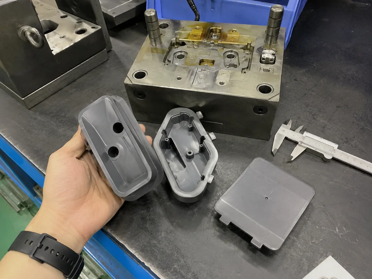 T1 plastic samples beside a rapid tooling mold and calipers