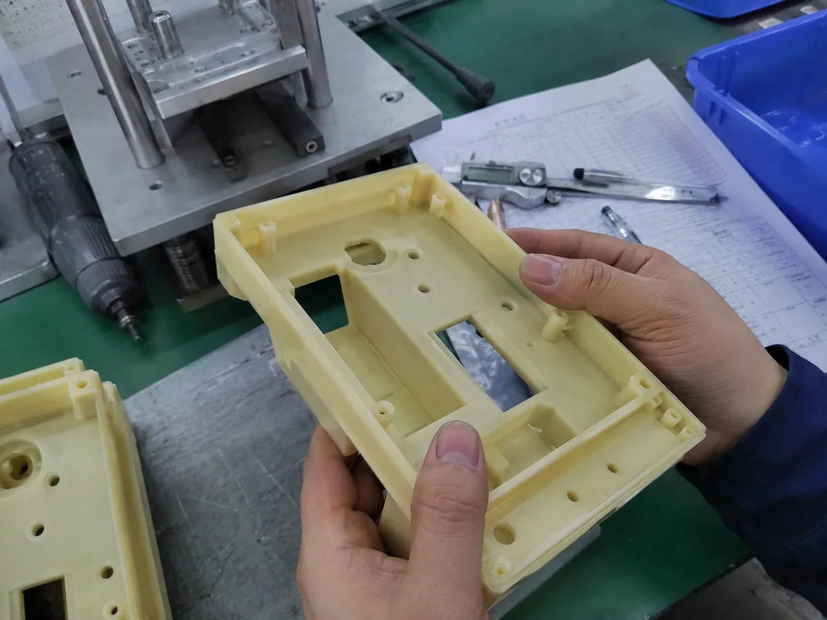 Urethane cast prototype checked by hand with drawing nearby