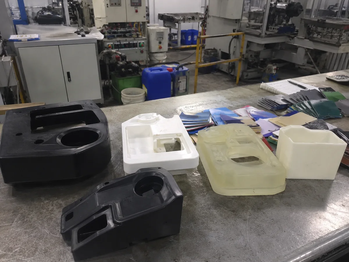 Finished urethane cast prototype parts in multiple colors on a bench