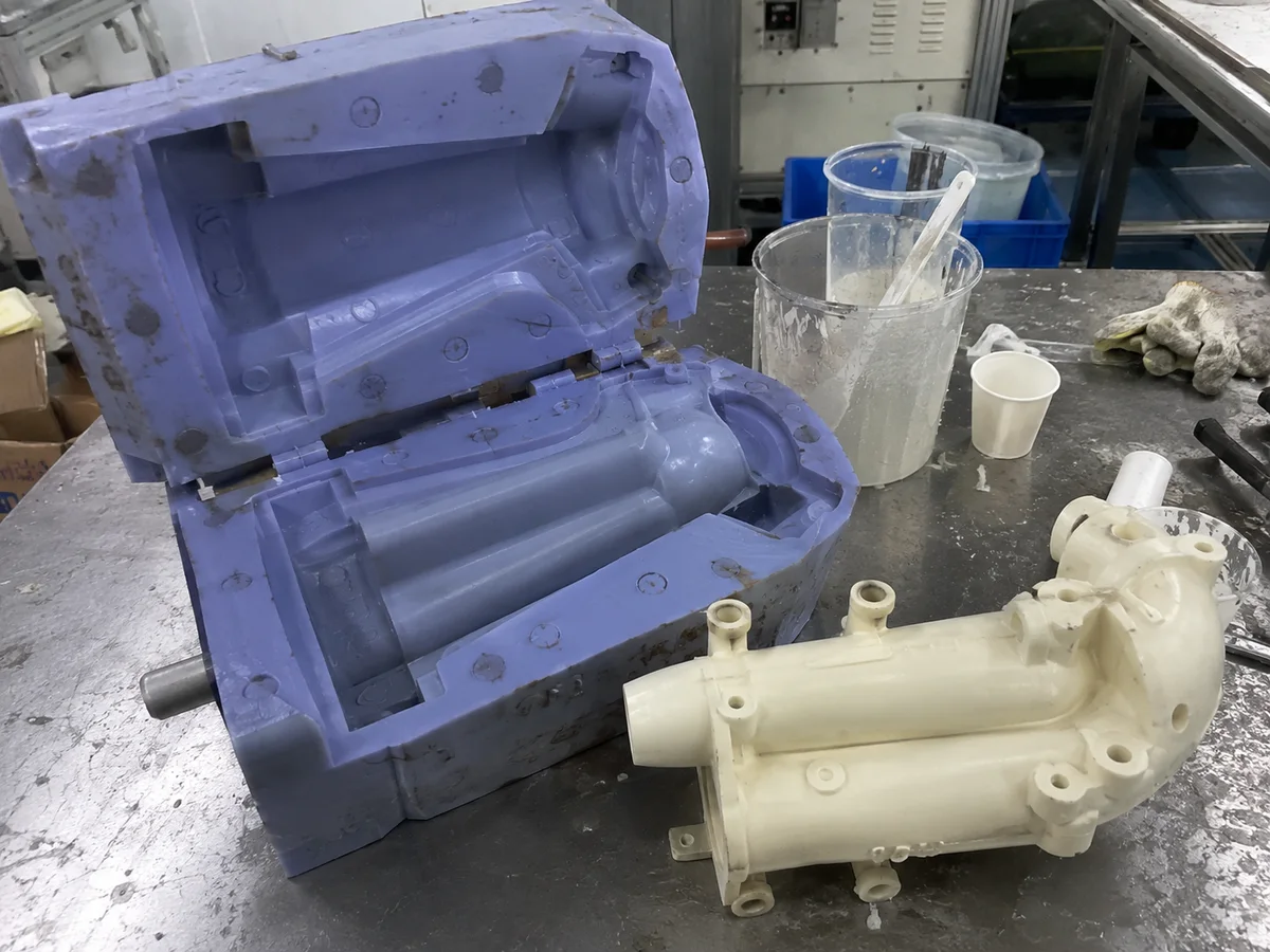 Silicone mold and urethane cast prototype housing on a bench